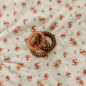 three coiled rubber bracelets